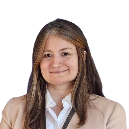 Female with brown long hair and white shirt and beige jacket smiling into camera